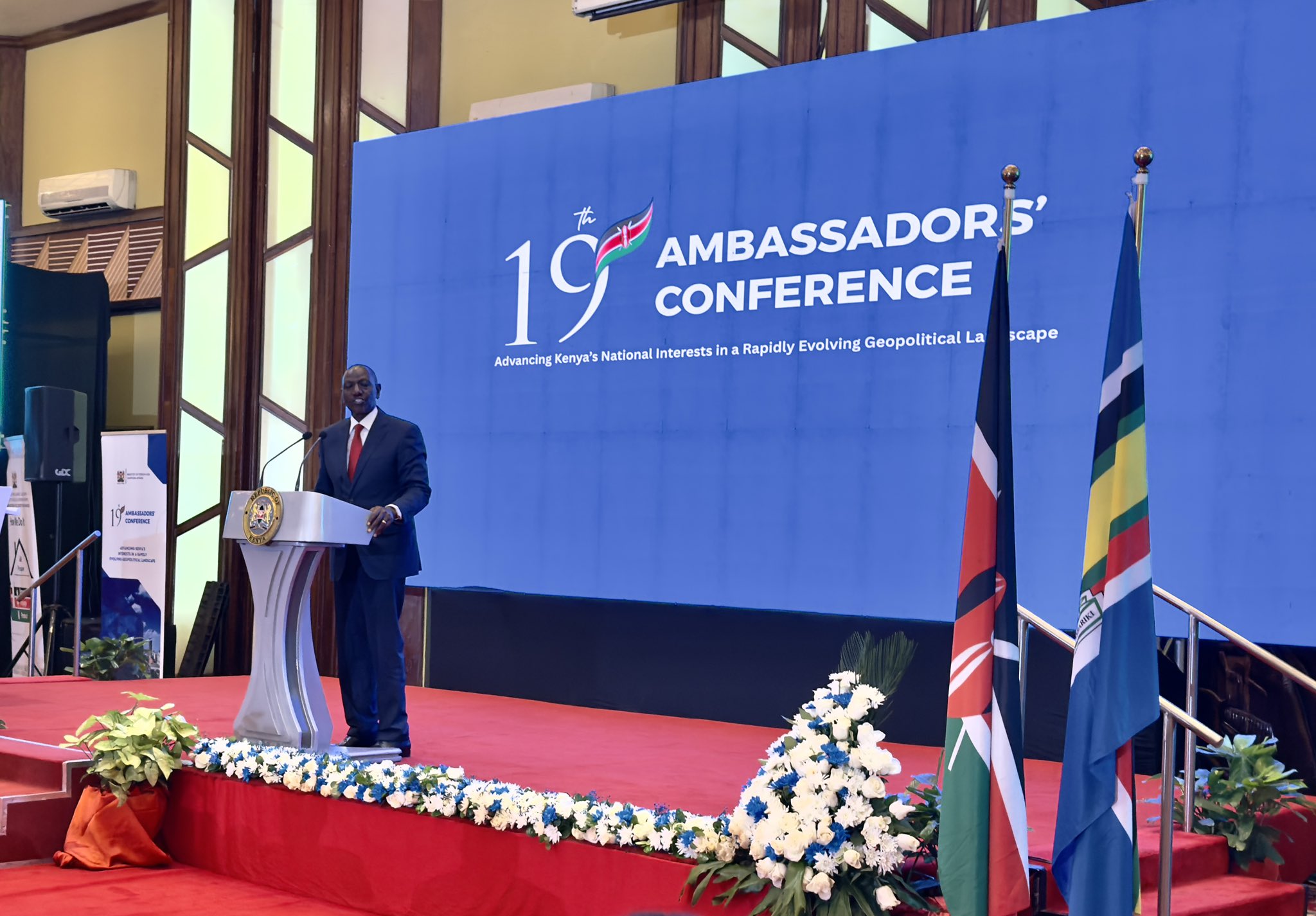 Kenya’s diplomatic leadership has convened in Nairobi for the 19th Ambassadors and High Commissioners Conference, bringing together envoys from across the world under the theme “Advancing Kenya’s Interests in a Rapidly Evolving Geopolitical Landscape.” The high-level meeting is being led by William Ruto and Musalia Mudavadi, signaling the government’s intent to recalibrate its foreign policy and strengthen Kenya’s position on the global stage. The conference has drawn participation from Kenya’s ambassadors, high commissioners, and consuls-general, who are expected to engage in strategic discussions focused on aligning diplomatic efforts with national priorities. Key areas of focus include economic diplomacy, diaspora engagement, trade expansion, and repositioning Kenya’s missions abroad for greater impact. Officials say the gathering comes at a time of shifting global dynamics, where geopolitical tensions, economic realignments, and emerging alliances are redefining international relations. Kenya is seeking to adapt by sharpening its diplomatic approach to better safeguard national interests and unlock new opportunities. A major highlight of the conference is an address by William Ruto, expected to outline Kenya’s foreign policy direction and priorities in the current global environment. The event also follows a reception honoring Monica Juma, marking her appointment to a senior role at the United Nations. Her appointment has been viewed as a significant milestone for Kenya’s diplomatic footprint on the international stage. Analysts note that the conference is likely to emphasize results-driven diplomacy, with increased pressure on missions abroad to deliver tangible benefits such as foreign investment, trade partnerships, and support for Kenyan citizens overseas. The inclusion of diaspora engagement as a central agenda item reflects growing recognition of the economic and social contributions of Kenyans living abroad, particularly through remittances and international networks. As deliberations continue, the outcomes of the conference are expected to shape Kenya’s diplomatic posture in the coming years, reinforcing its role as a key regional and global player in an increasingly complex international landscape.